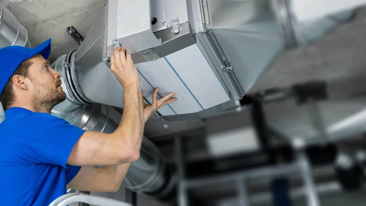 a man working on commercial air duct system